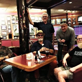Brian Wahlstad (far left), Larry Wiegand (standing), GR Svenddal, and friends